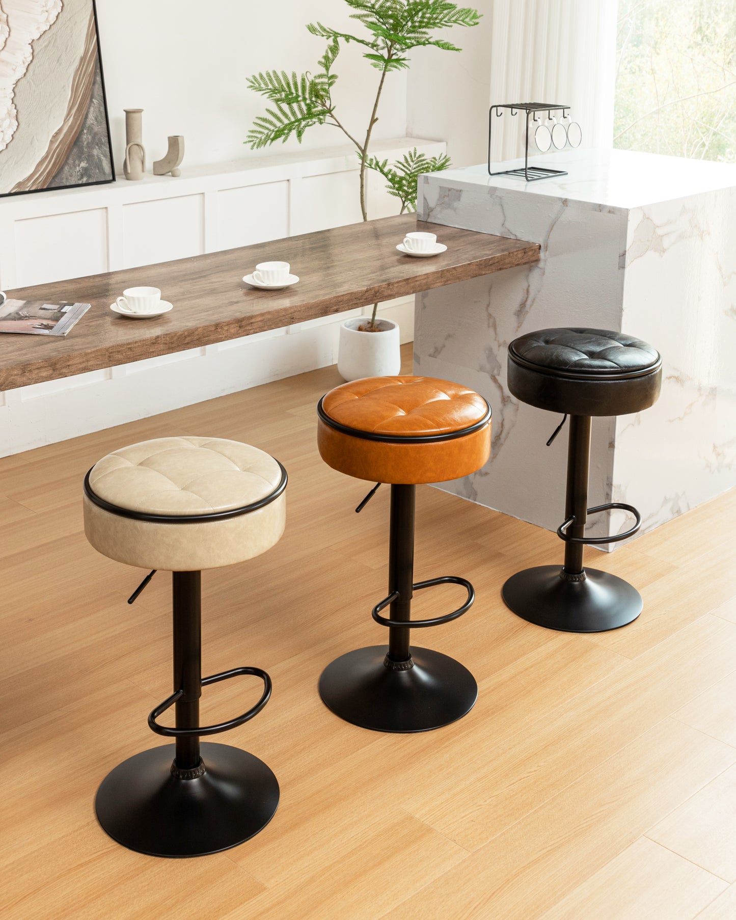 Three adjustable height bar stools in cream brown and black faux leather with black metal bases