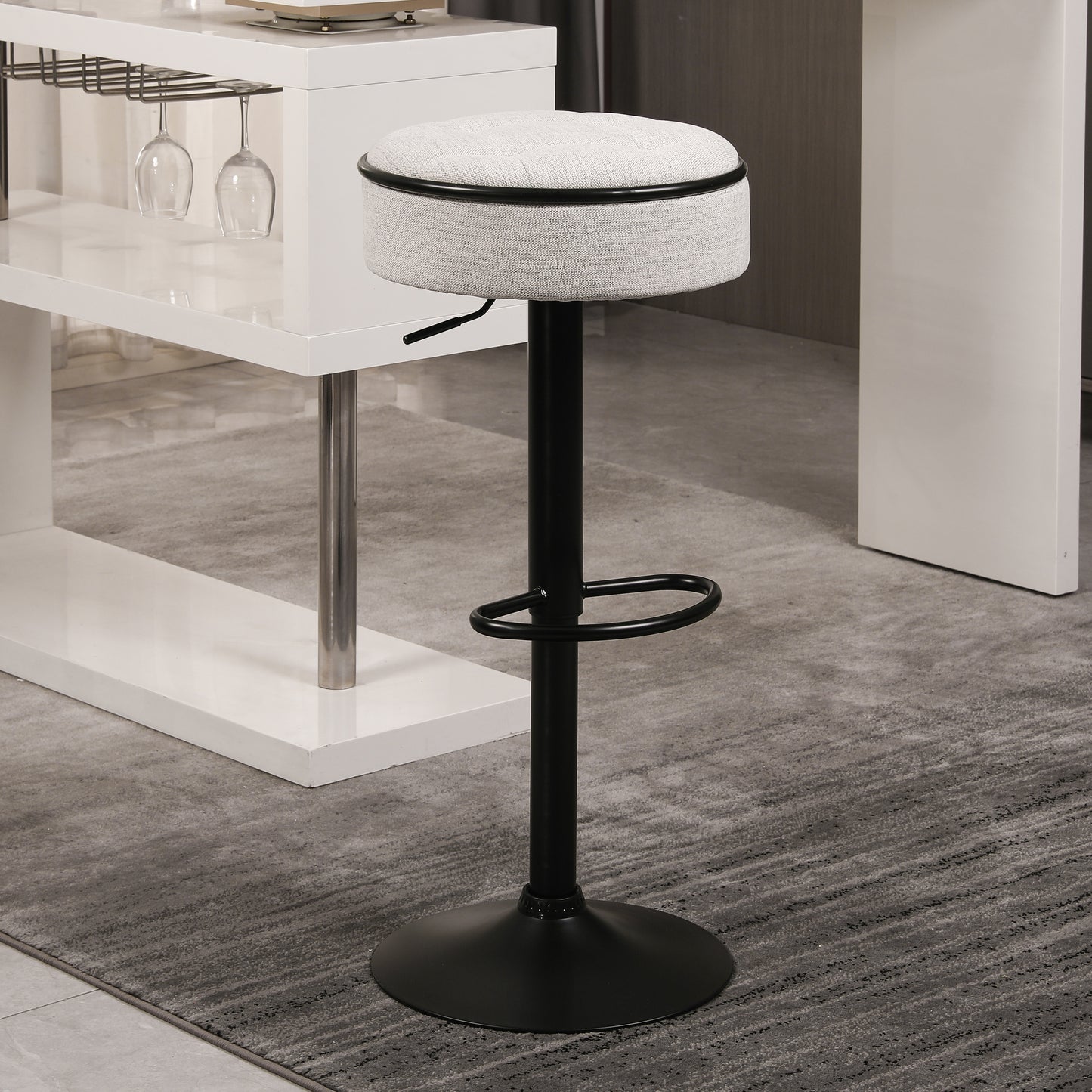 Gray upholstered bar stool with adjustable height and black metal base