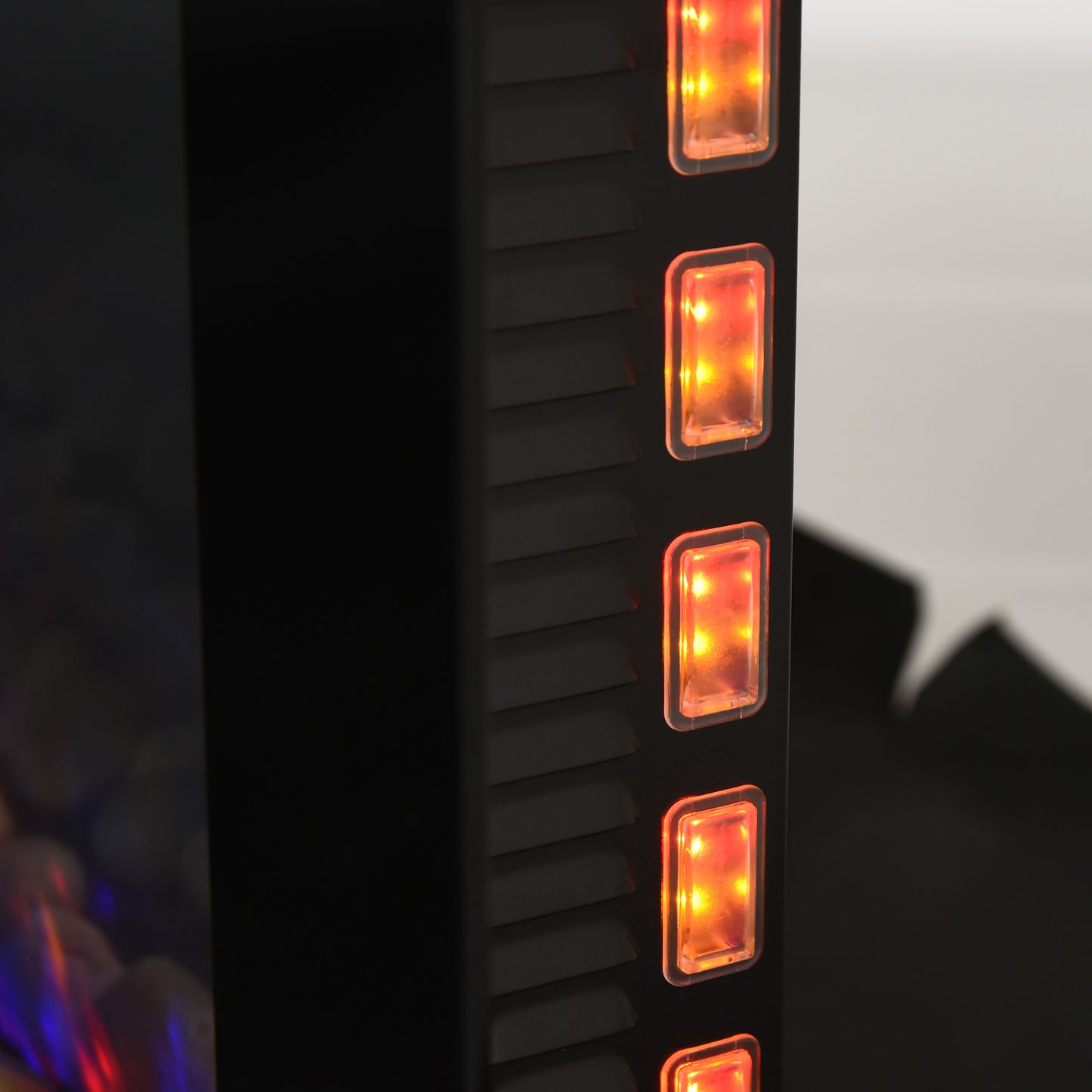 Close up of a black vertical cabinet with amber illuminated rectangular buttons