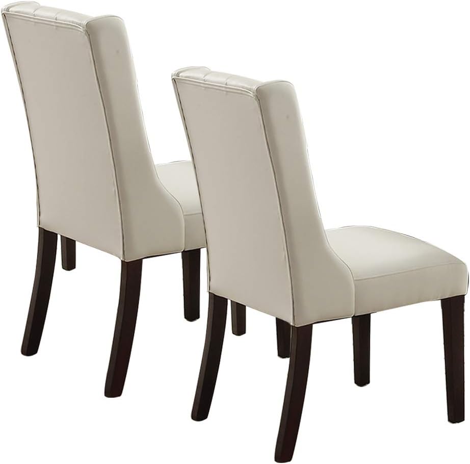 Two cream upholstered dining chairs with dark wood legs on white background