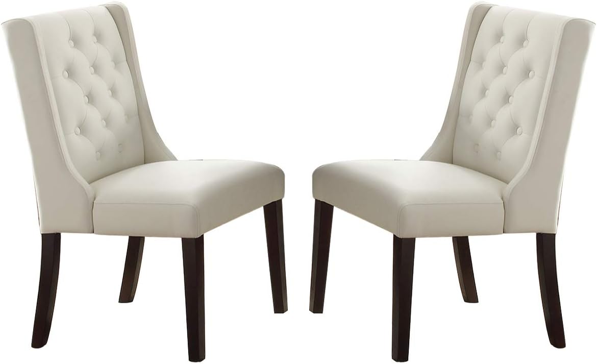 Cream upholstered dining chairs with button tufting and dark wood legs