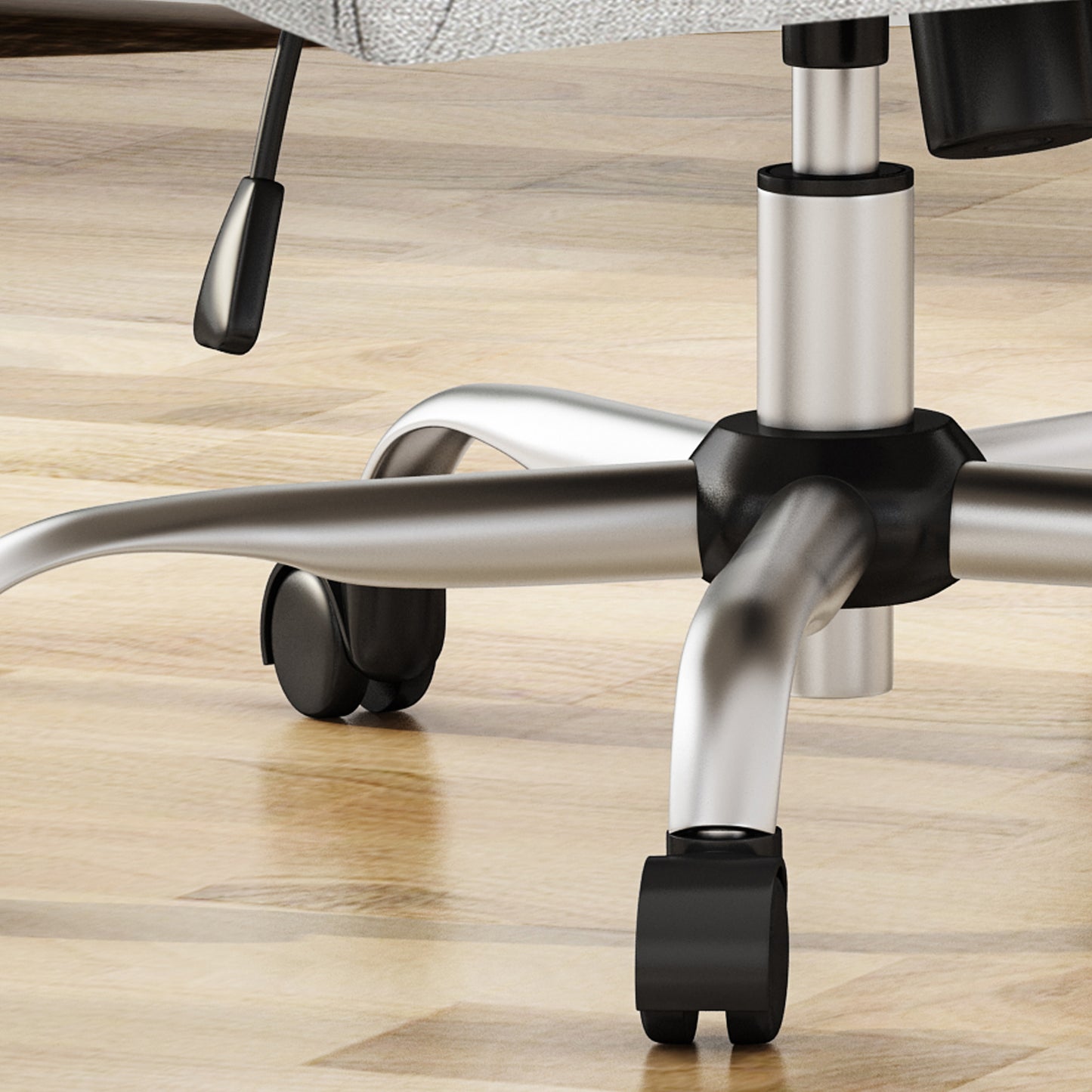 Silver swivel office chair base with five caster wheels on hardwood floor