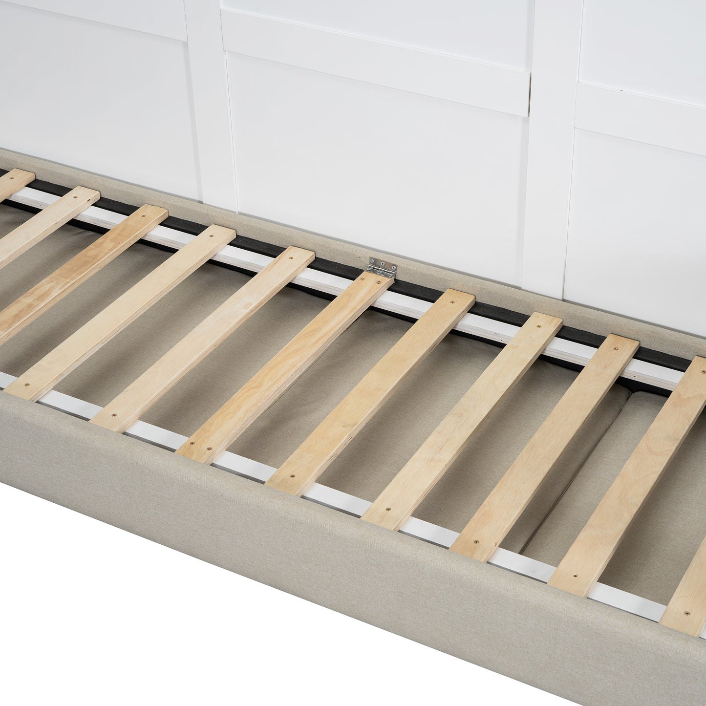 Closeup of a beige upholstered bed frame with a wooden slatted base and white headboard