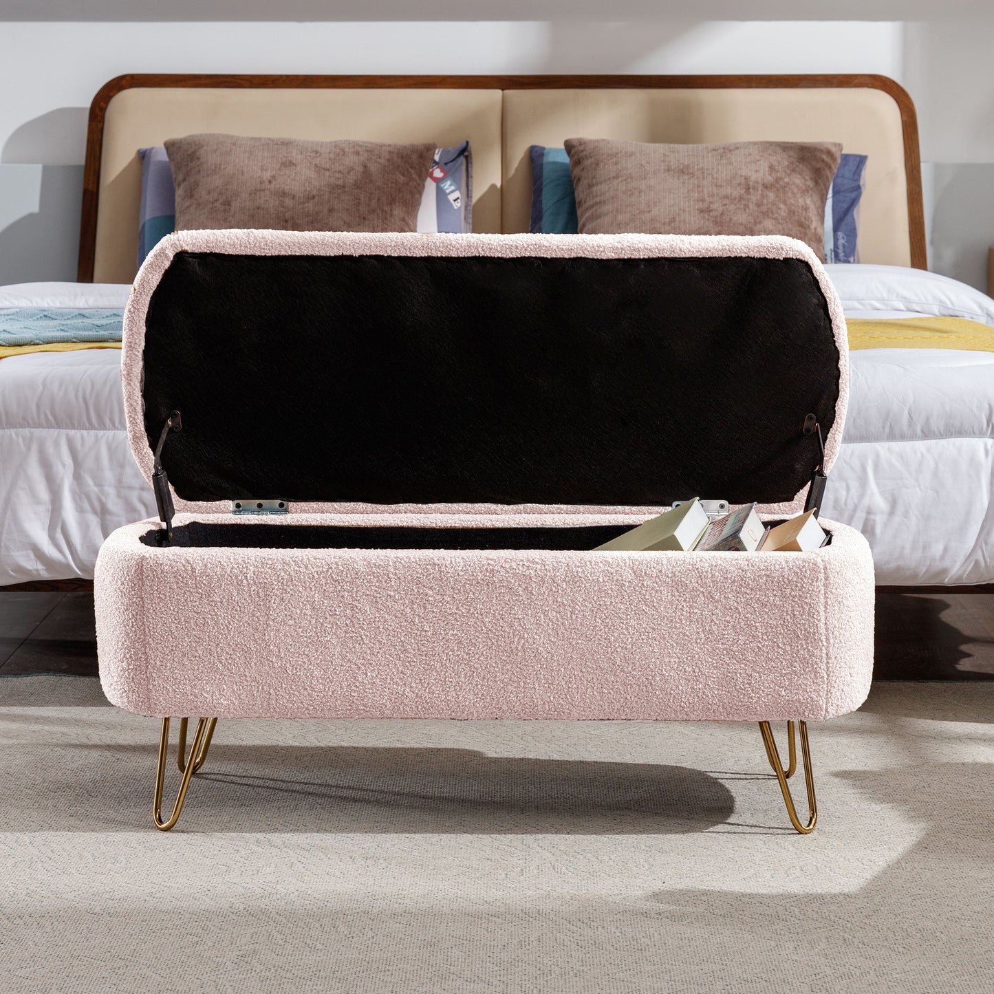 Pink sherpa storage bench with open lid revealing books