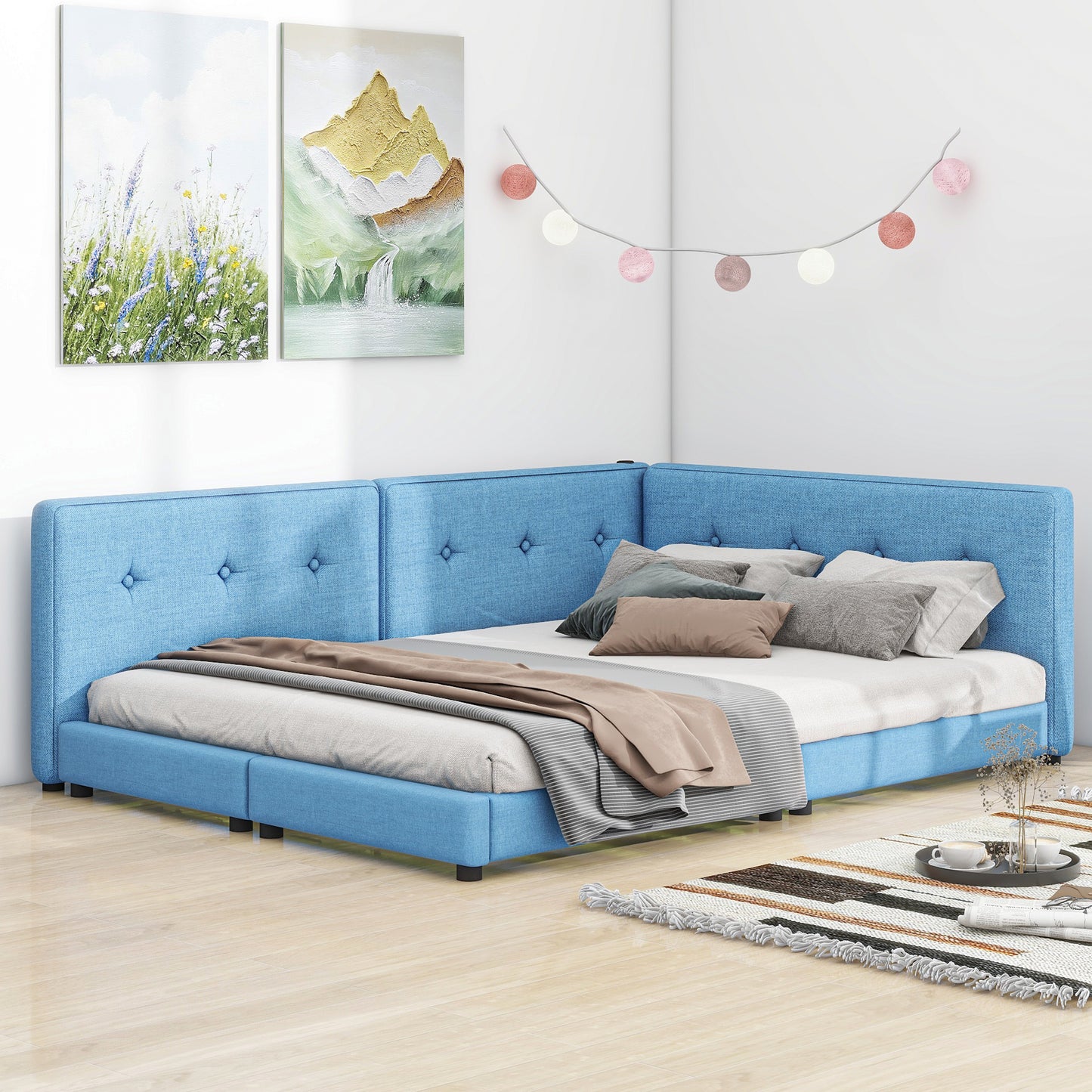 Blue tufted corner bed with white linens and decorative pillows