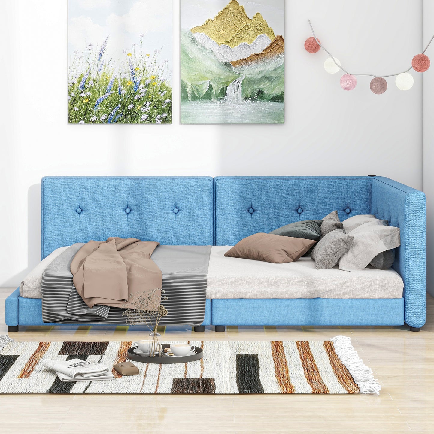 Blue upholstered convertible sofa bed with button tufts