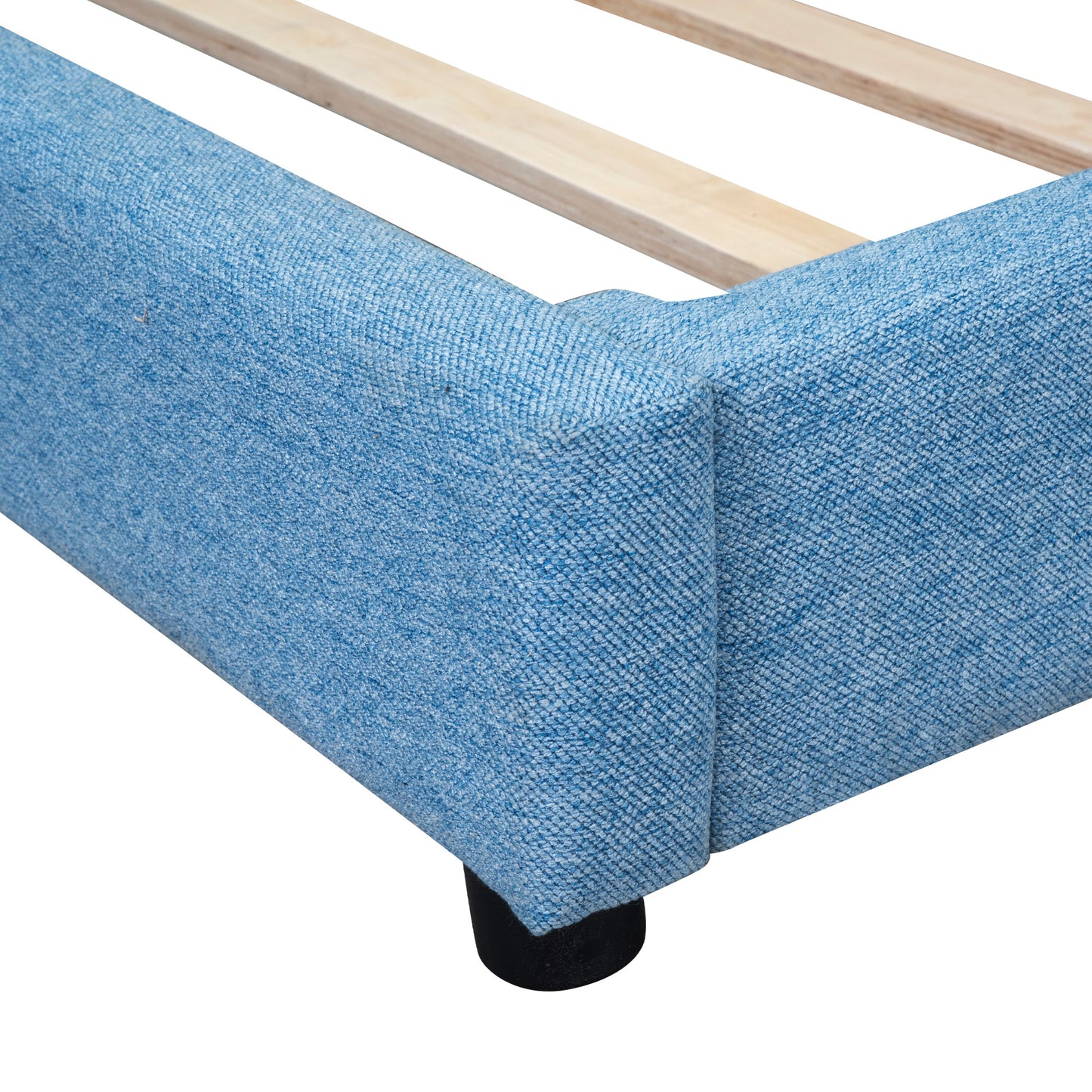 Closeup of a blue upholstered bed frame corner with wooden slats visible