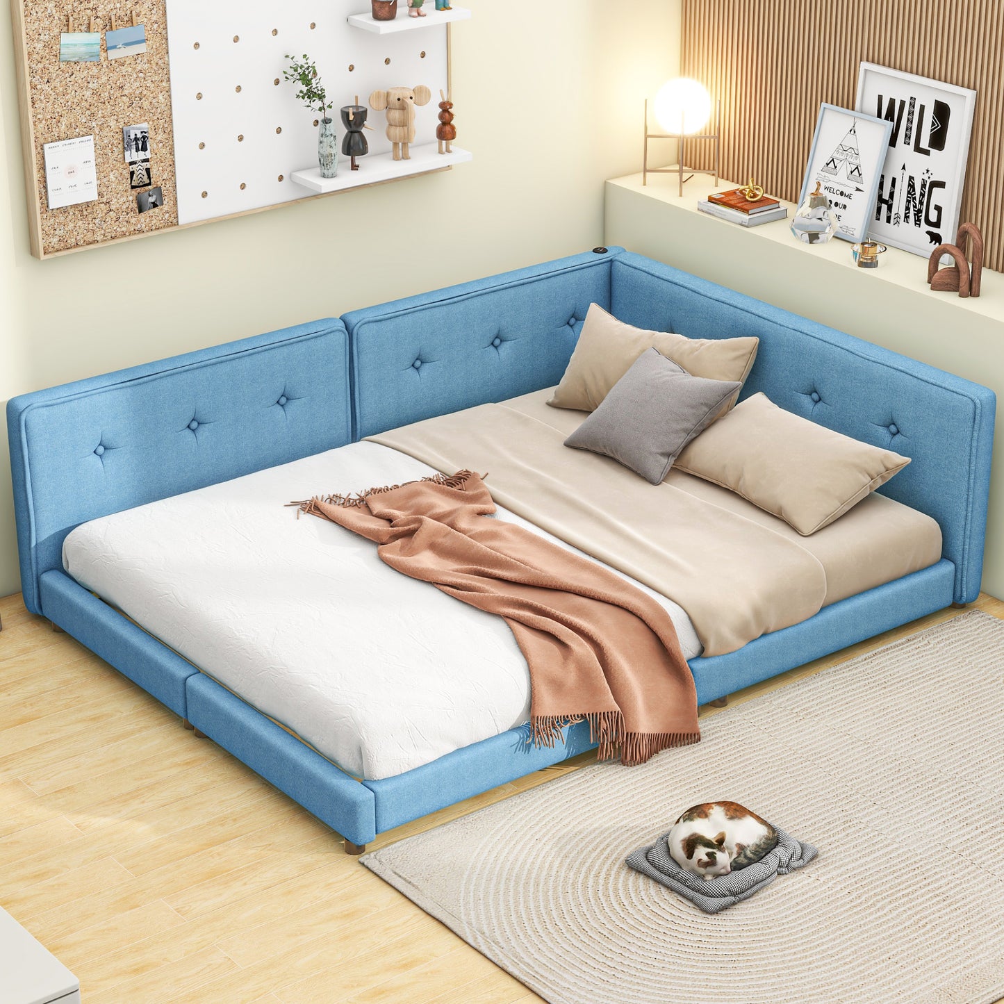 Blue upholstered sectional bed with button tufting and beige cushions