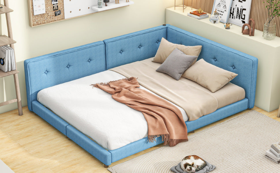 Blue upholstered daybed with tufted headboard and bedding