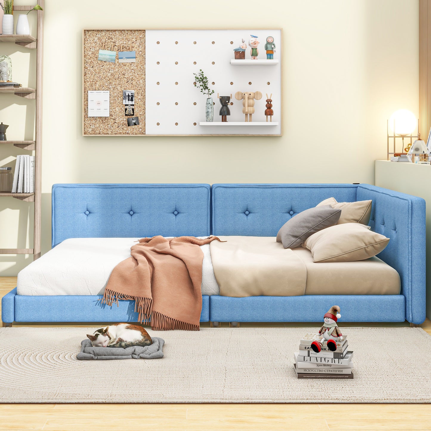 Tufted blue fabric sofa bed with throw blanket and pillows