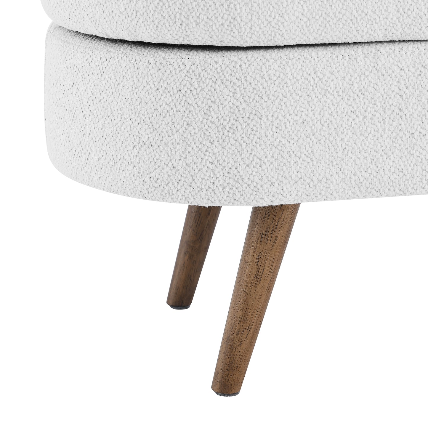 Closeup of a textured white upholstered ottoman with angled wooden legs