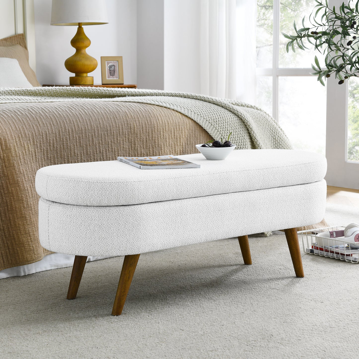 White boucle storage ottoman with tapered wooden legs