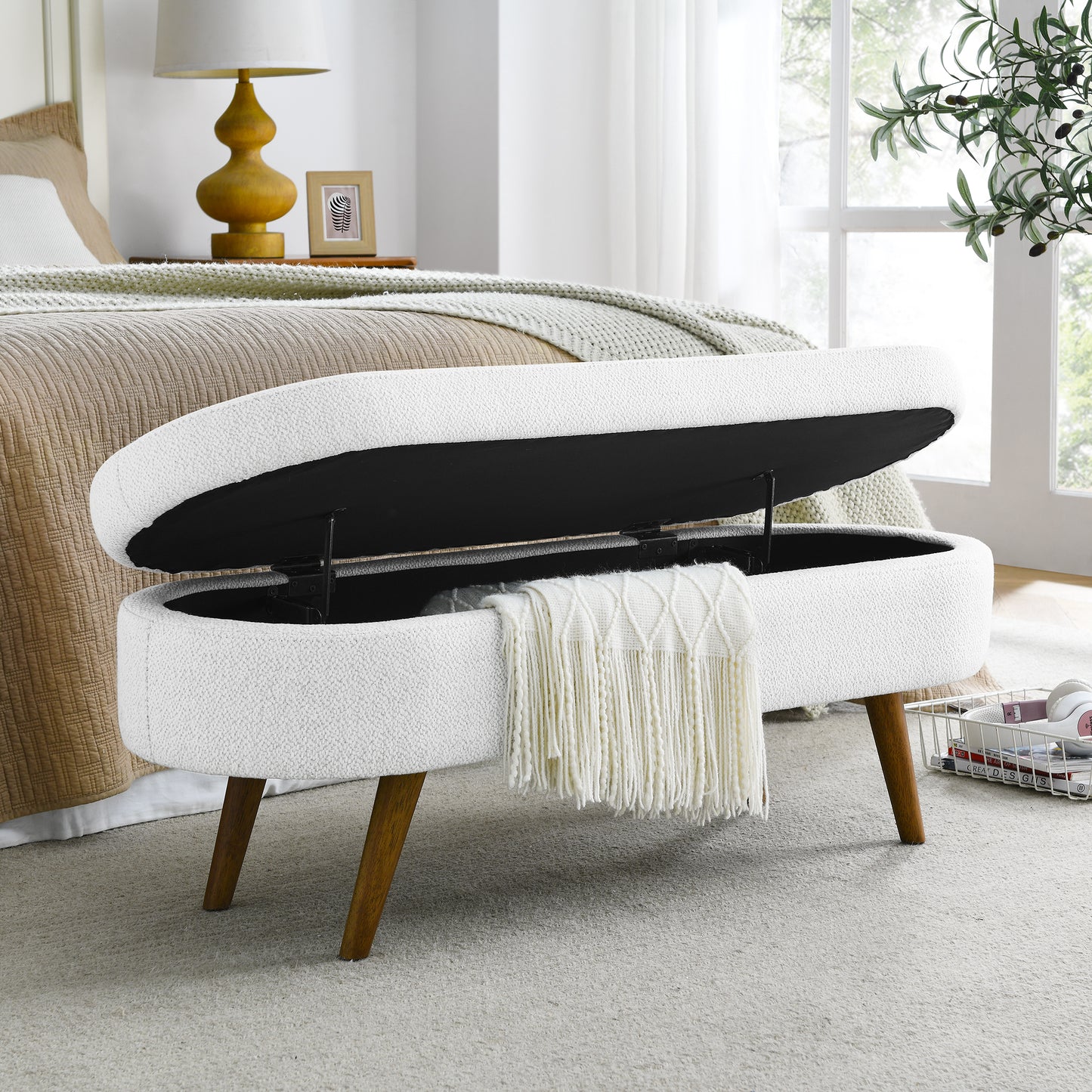 White boucl storage ottoman with open lid and wooden legs