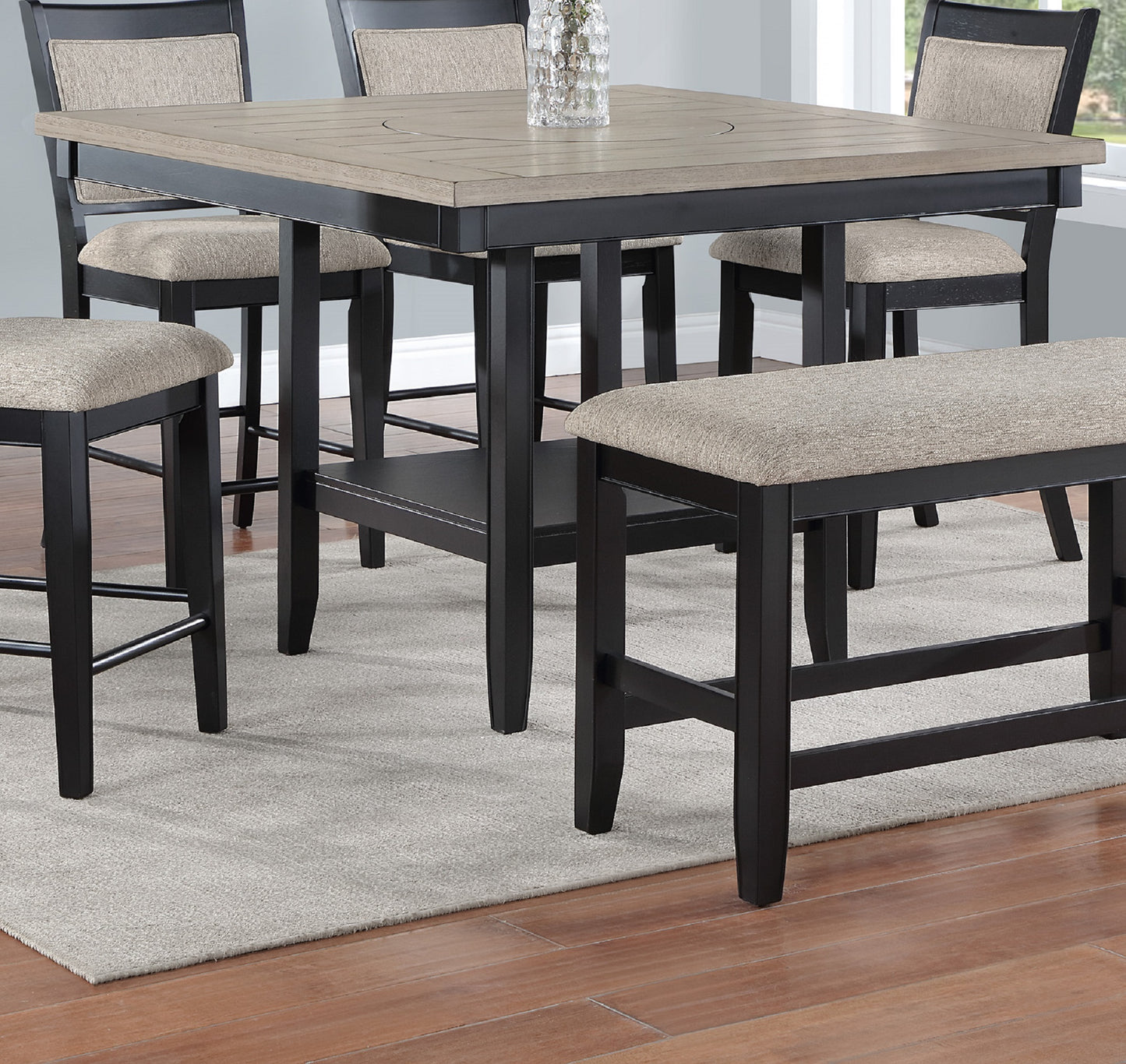 Black and light wood counter height table with upholstered stools and bench