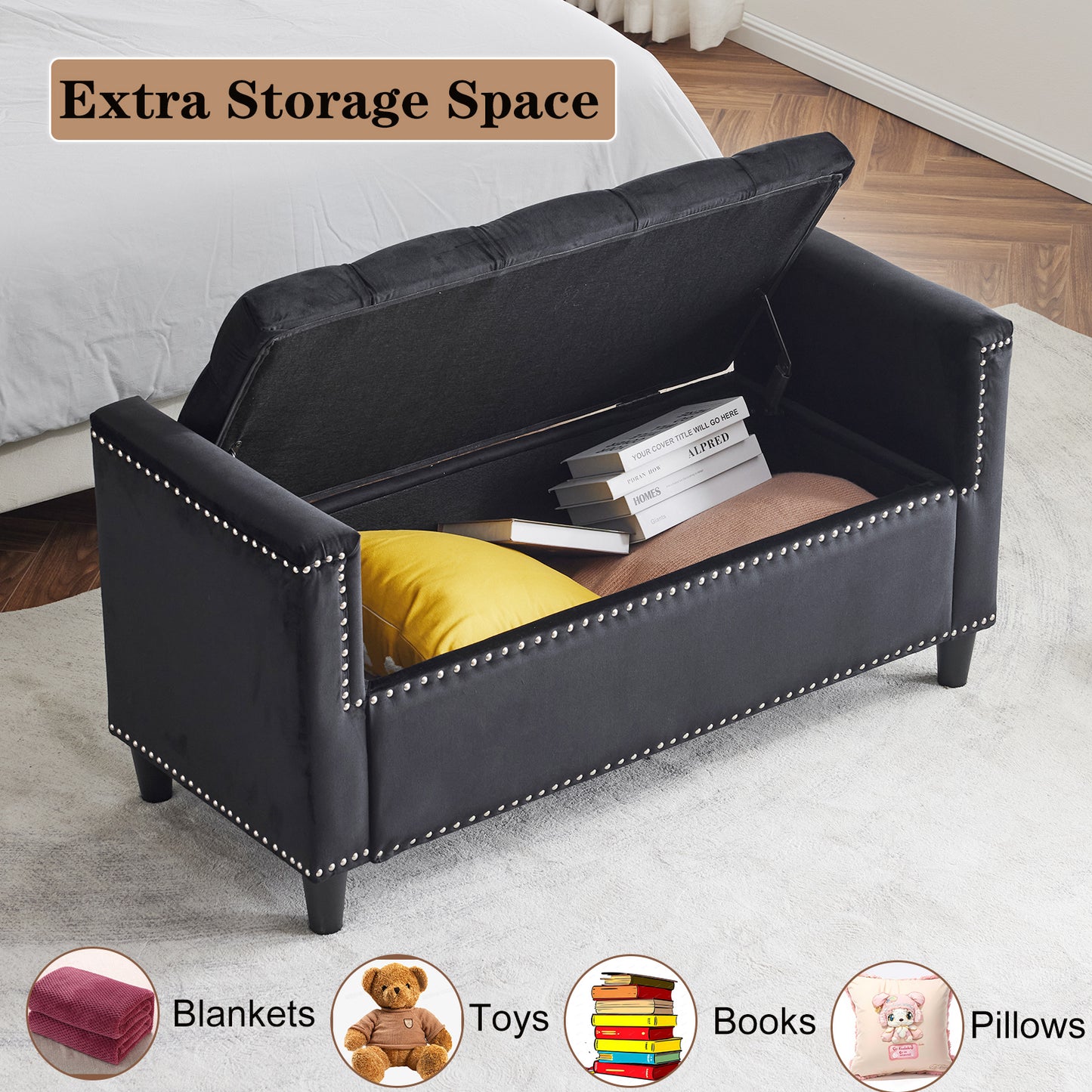 Black velvet storage bench with silver stud trim and open lid revealing books