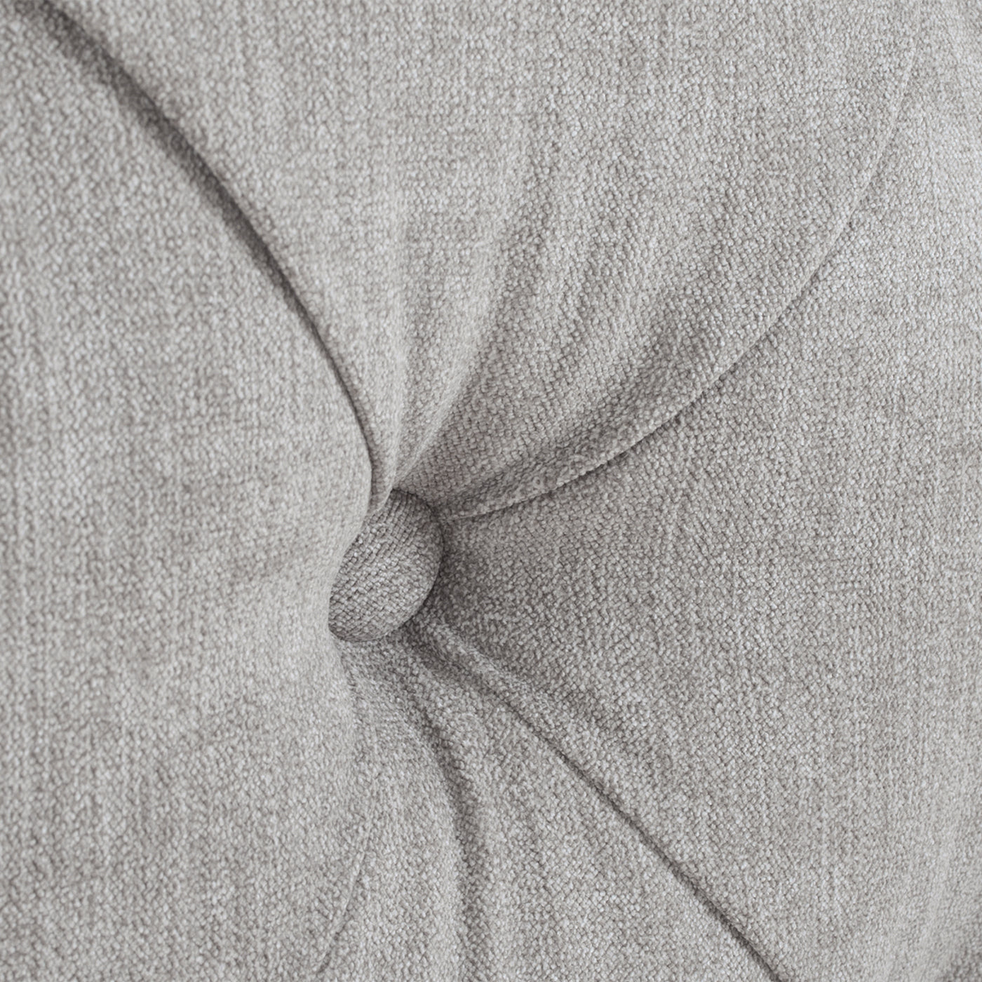 Closeup of tufted grey fabric texture with button detail