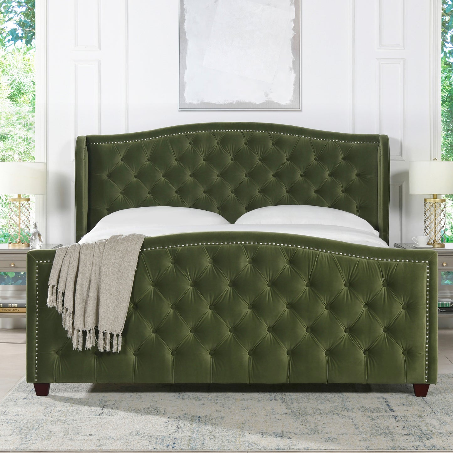 Deep green velvet tufted bed frame with silver nailhead trim and rolled arms