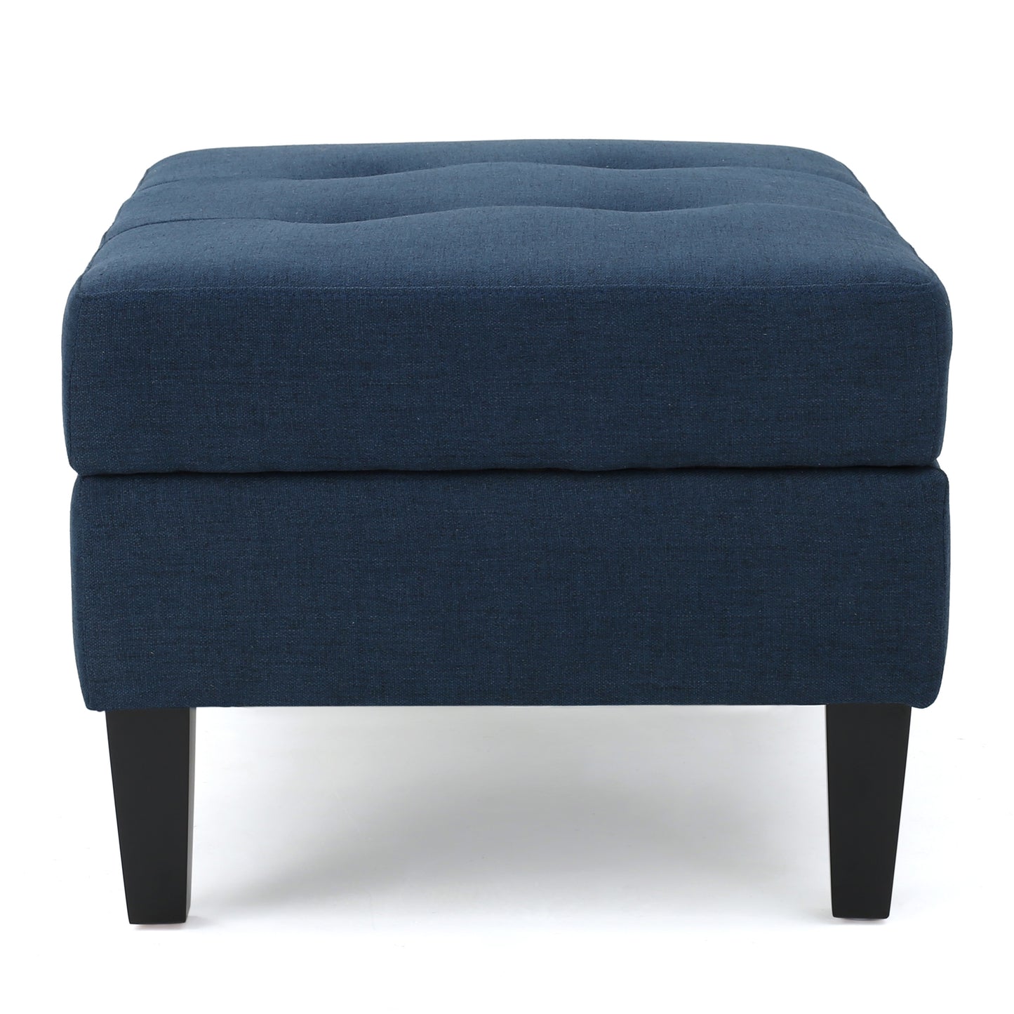 Dark blue upholstered ottoman with tufted top and black legs