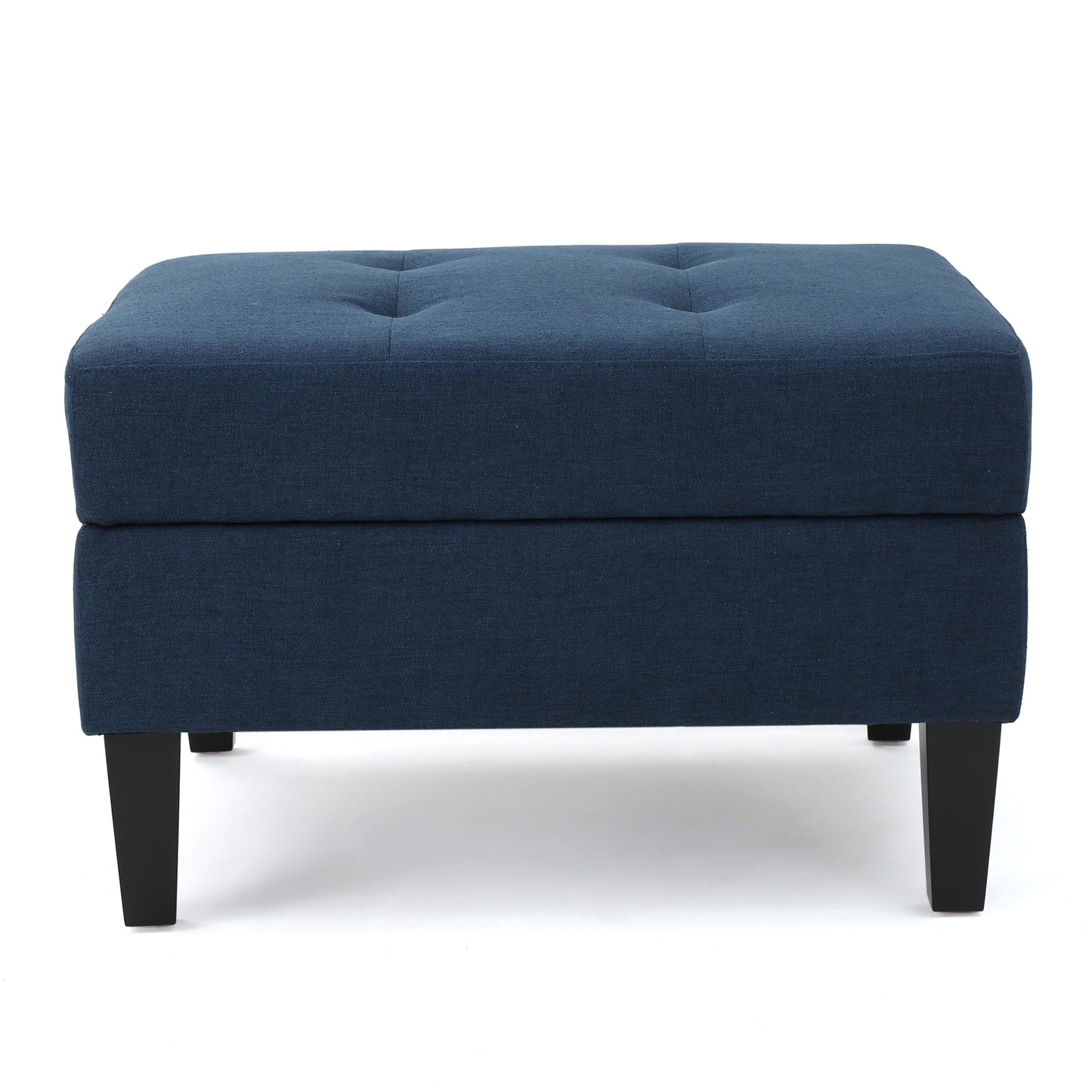 Tufted navy blue fabric ottoman with dark wooden legs and silver buttons