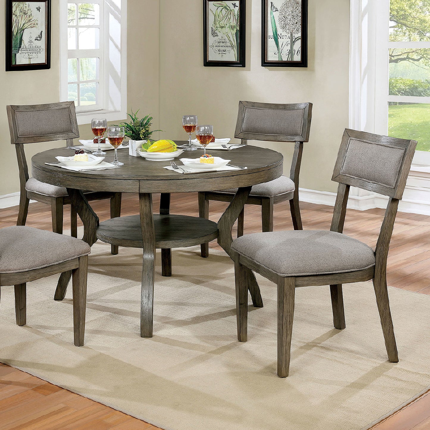 Round grey wood dining table with upholstered chairs