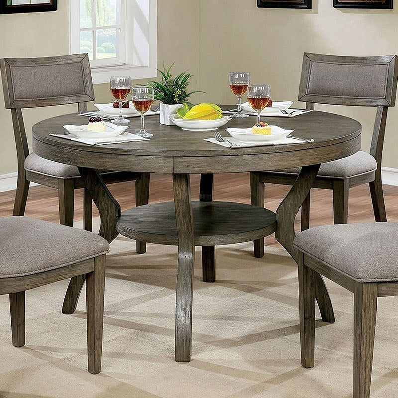Round gray wood dining table with upholstered chairs