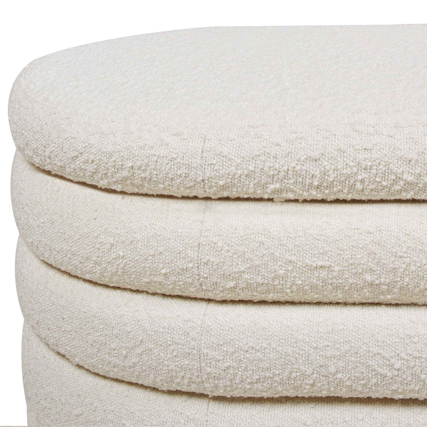 Closeup of textured ivory boucle fabric upholstery on a modern ottoman