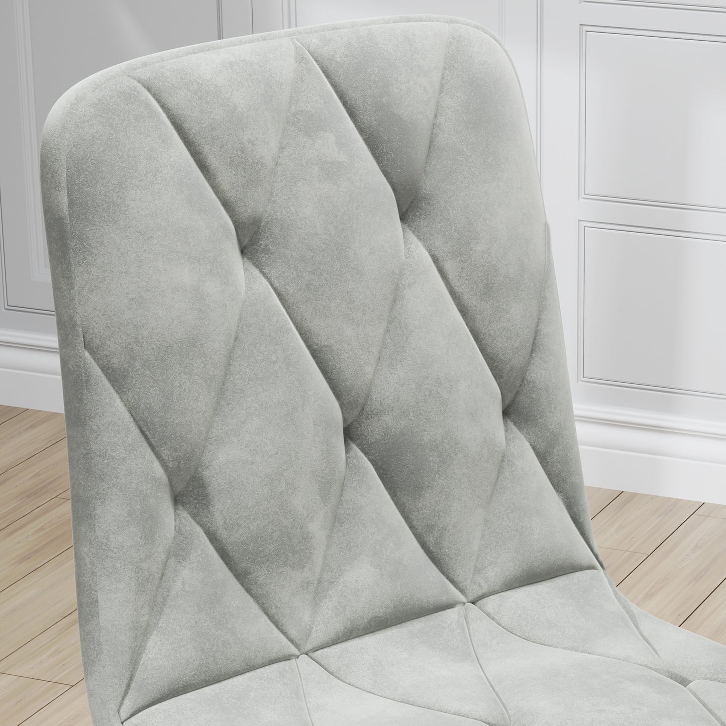 Light gray upholstered chair with diamond tufting detail and velvet texture