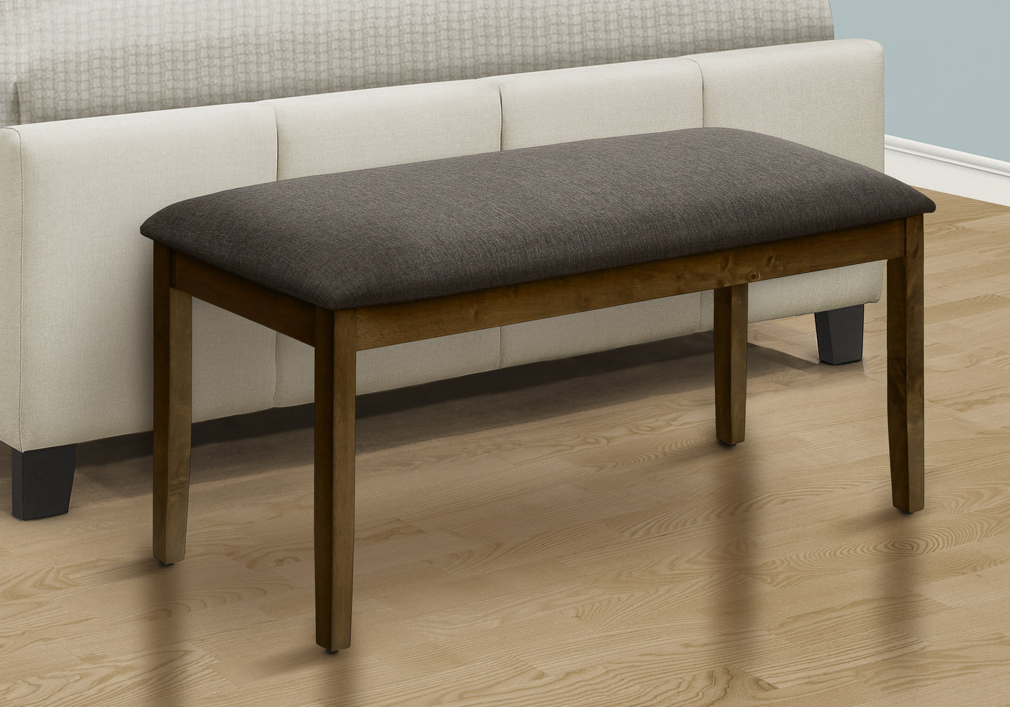 Dark gray upholstered wood bench with tapered legs
