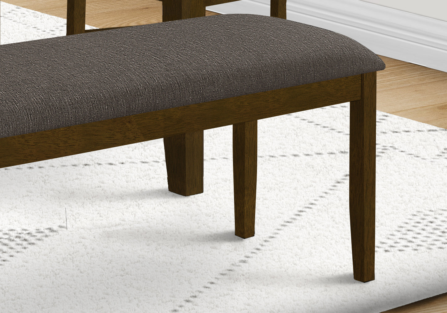 Dark gray upholstered dining bench with dark wood legs