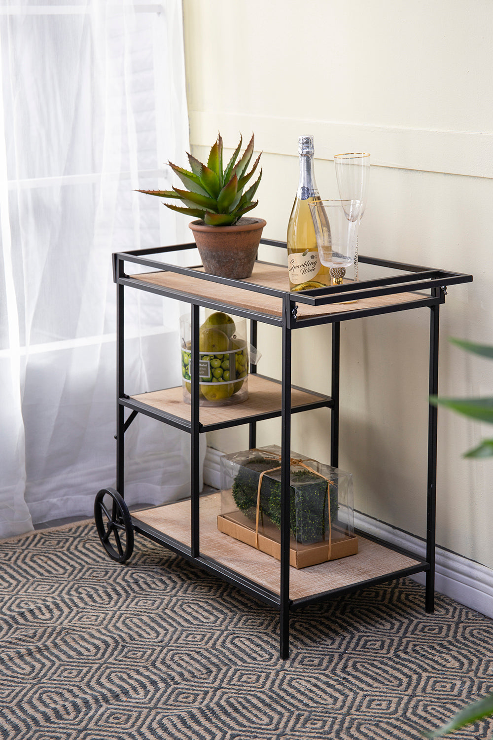 Modern metal and wood bar cart with wheels and decorative accents