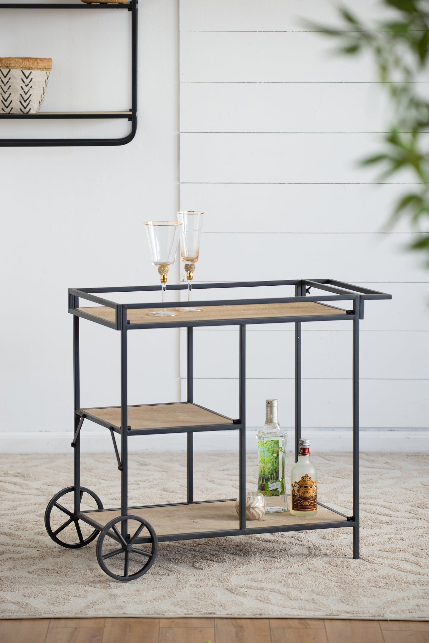 Modern industrial metal bar cart with wooden shelves and decorative wheels