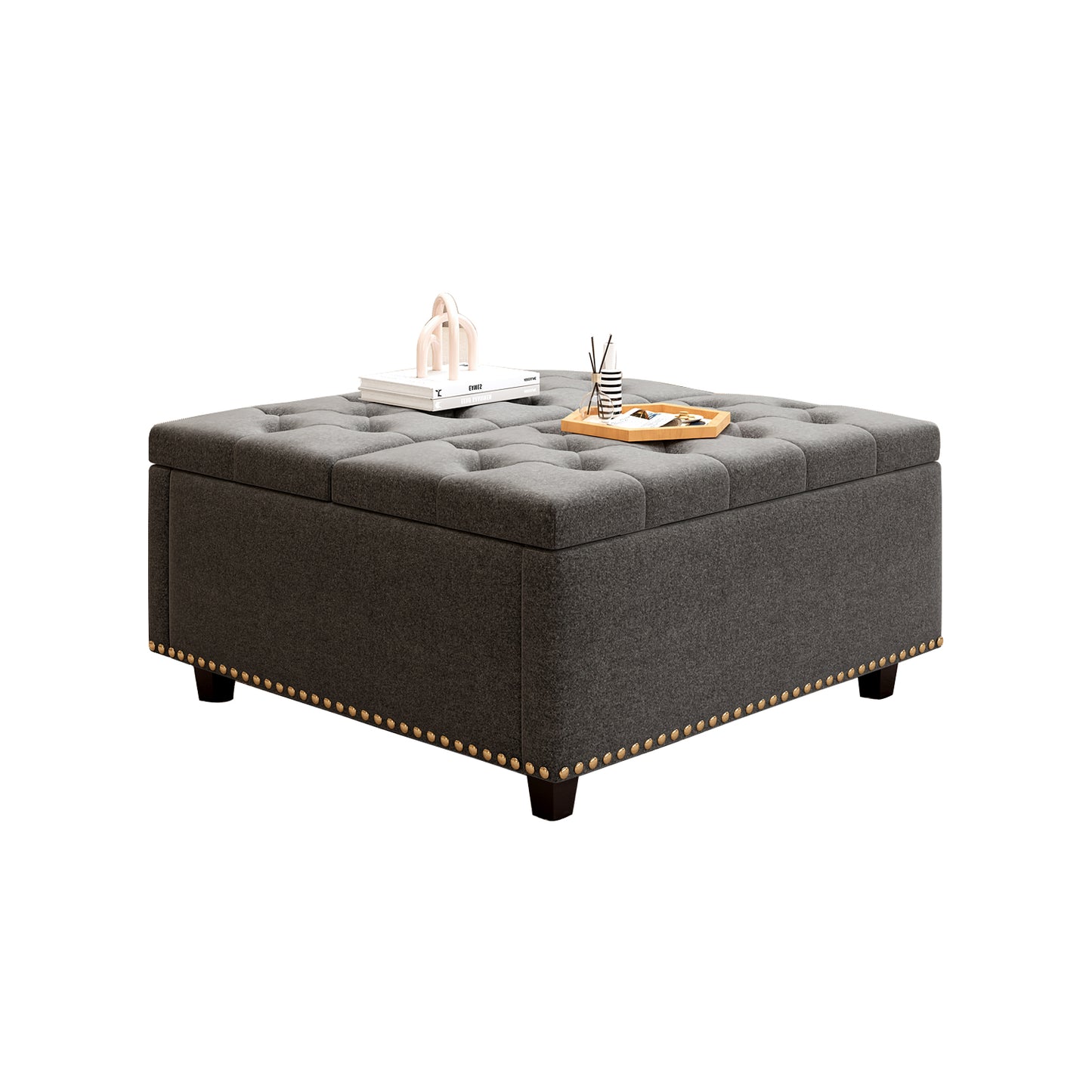 Dark grey tufted storage ottoman with decorative nailhead trim and wooden legs