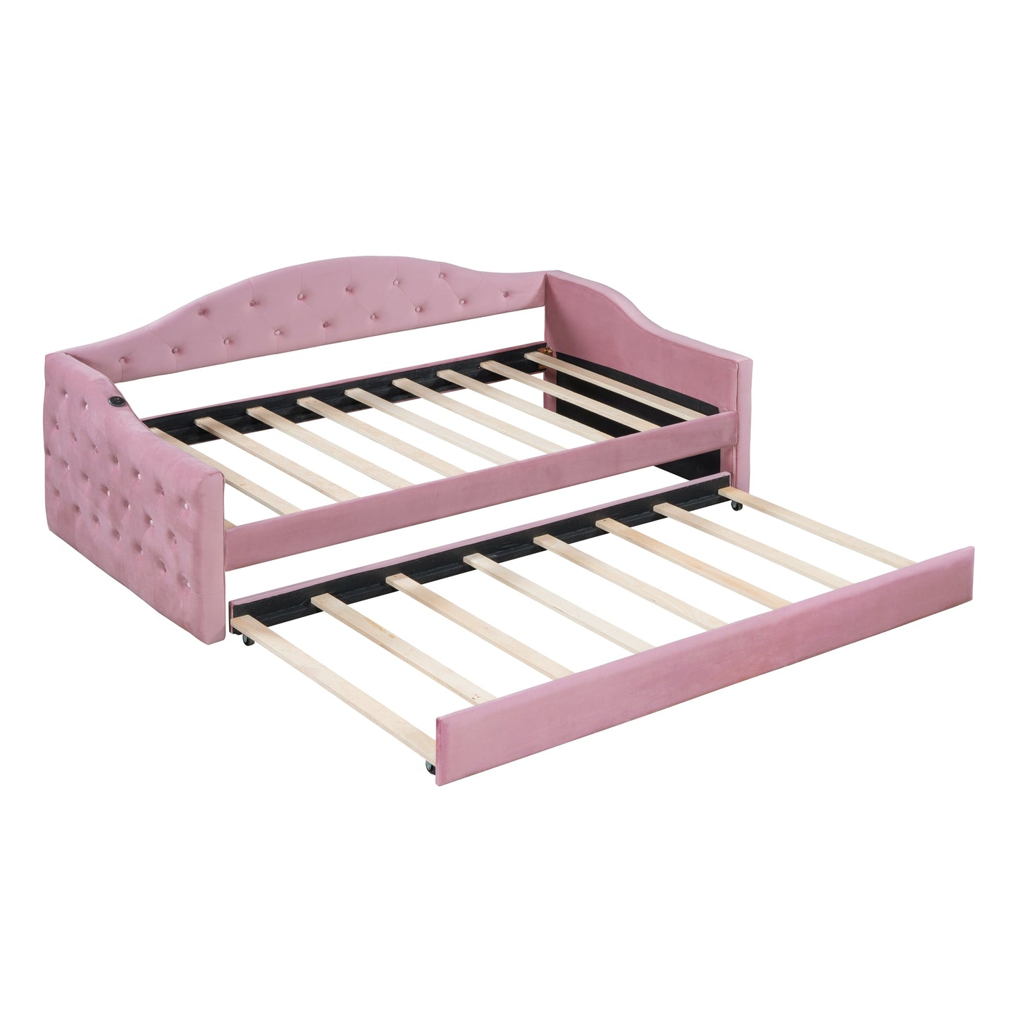 Pink velvet daybed with pullout trundle featuring tufted headboards and wooden slats for mattress support