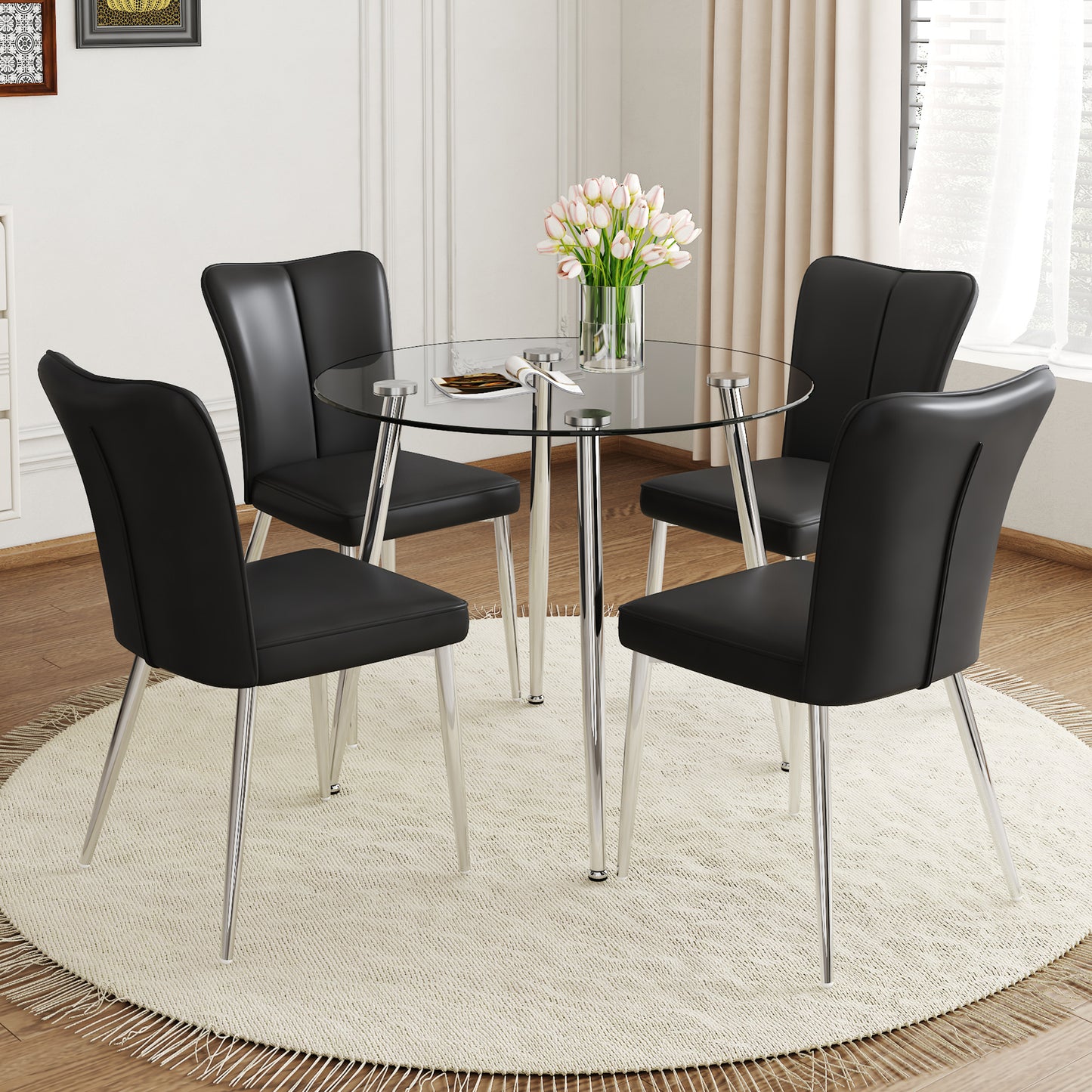 Round glass dining table with four black faux leather chairs