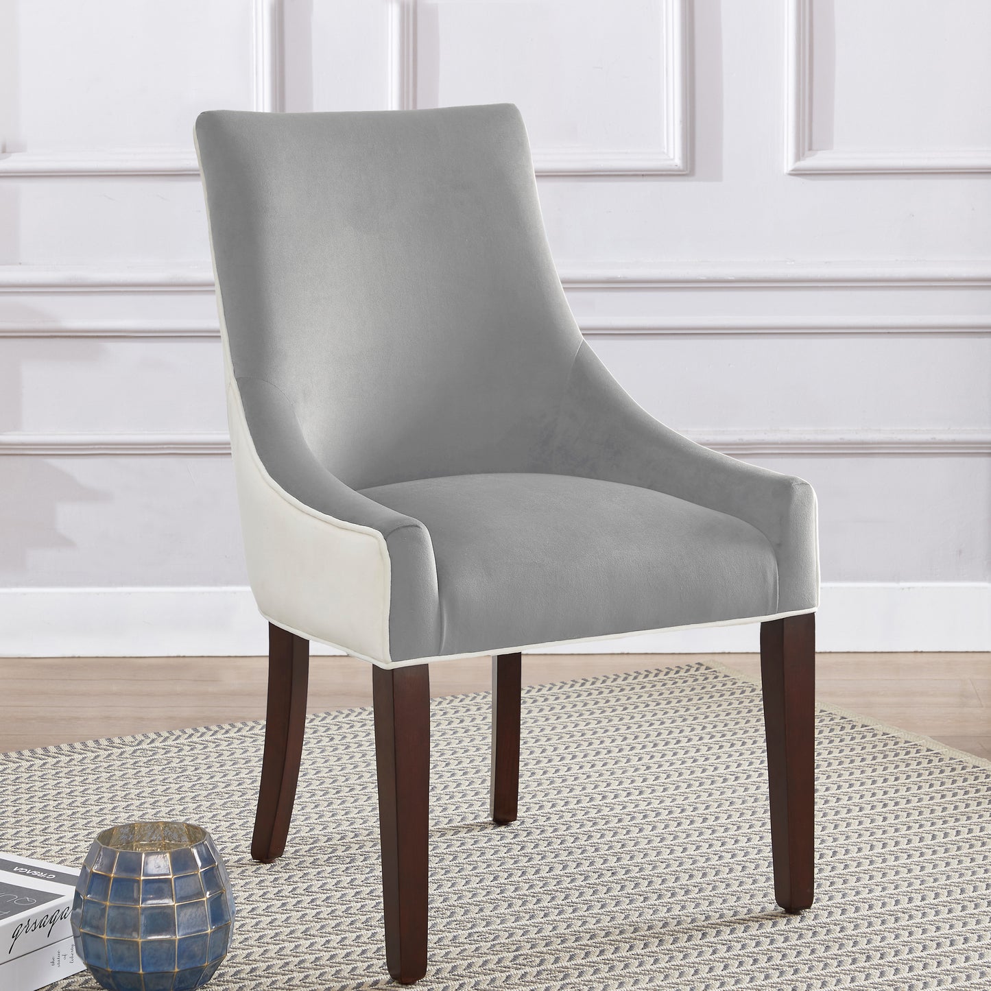 Grey velvet dining chair with cream trim and dark wood legs