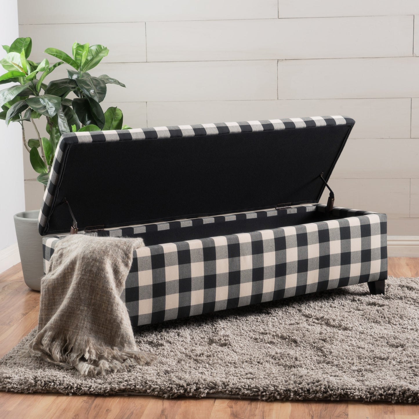 Buffalo check storage ottoman with open lid revealing black interior