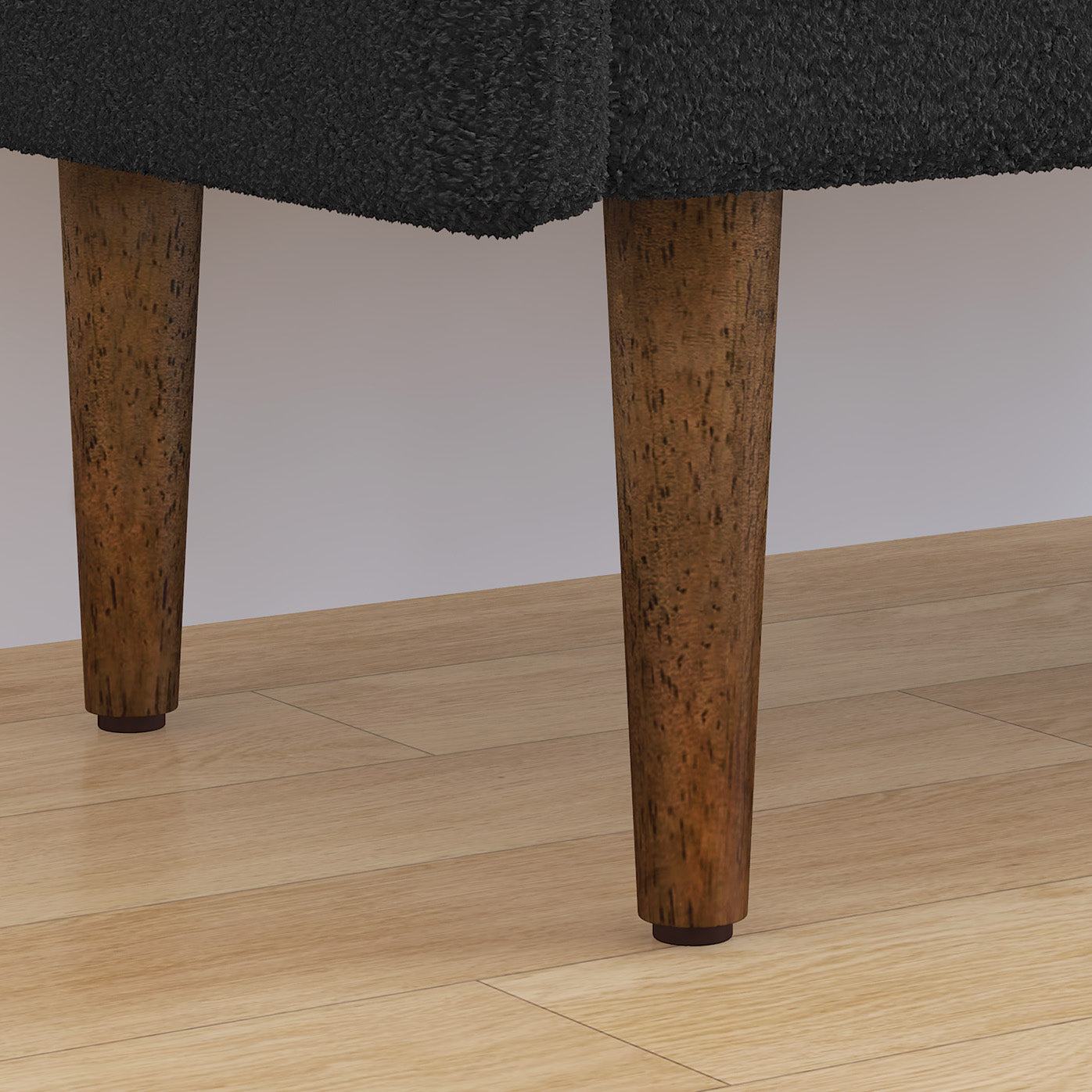 Dark grey textured sofa legs with tapered wooden feet