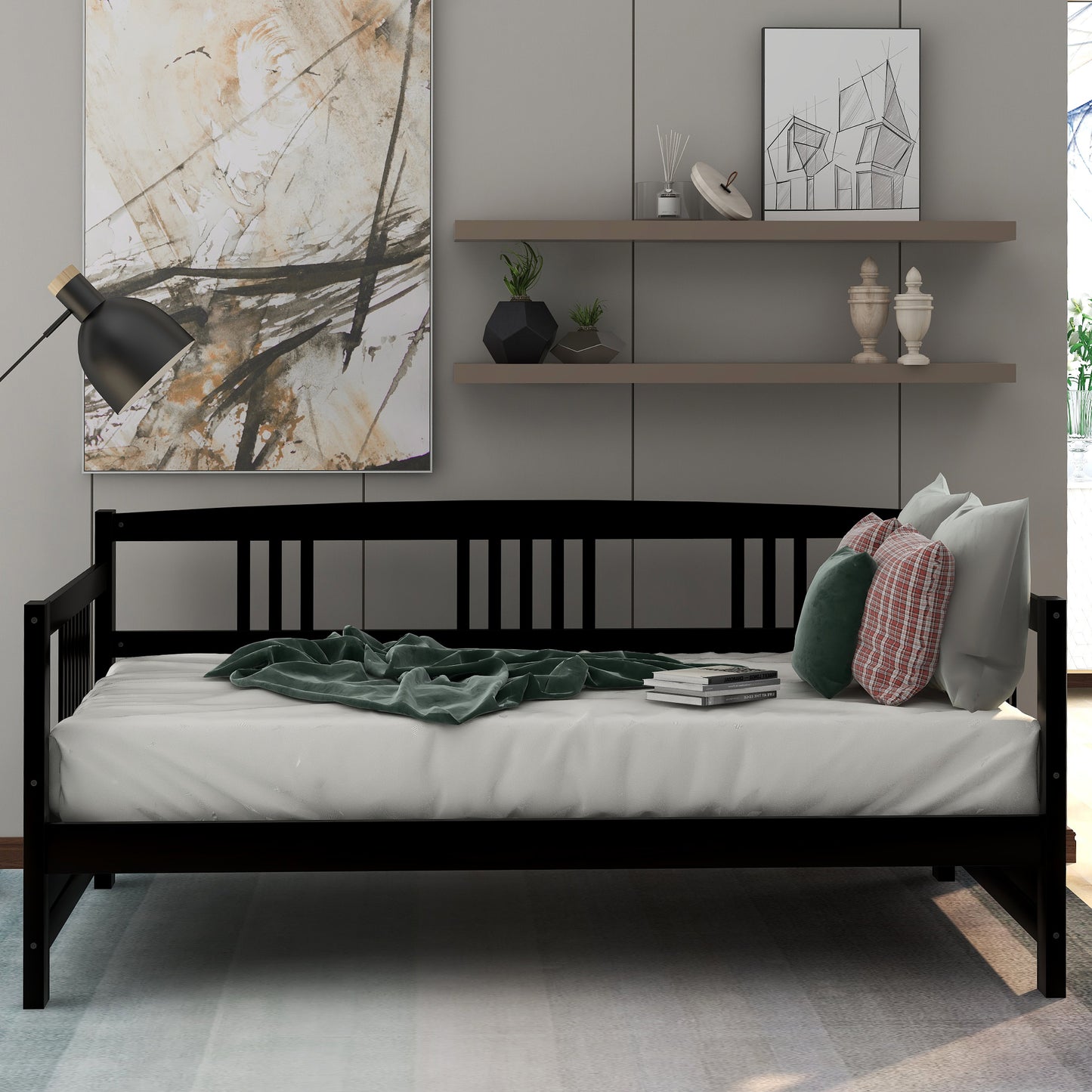 Black wooden daybed with white mattress and green throw