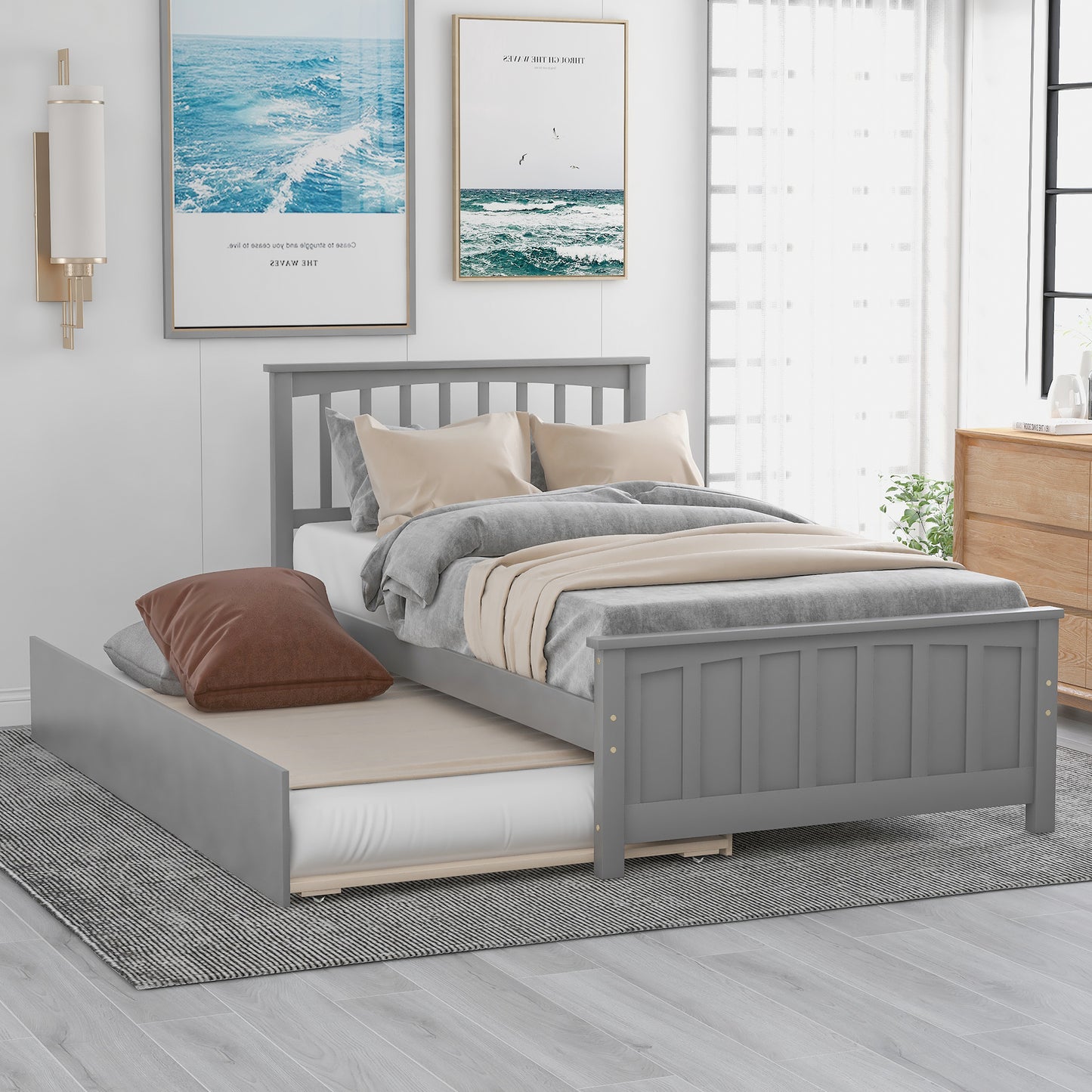 Grey wooden daybed with pullout trundle and upholstered cushions perfect for guest rooms