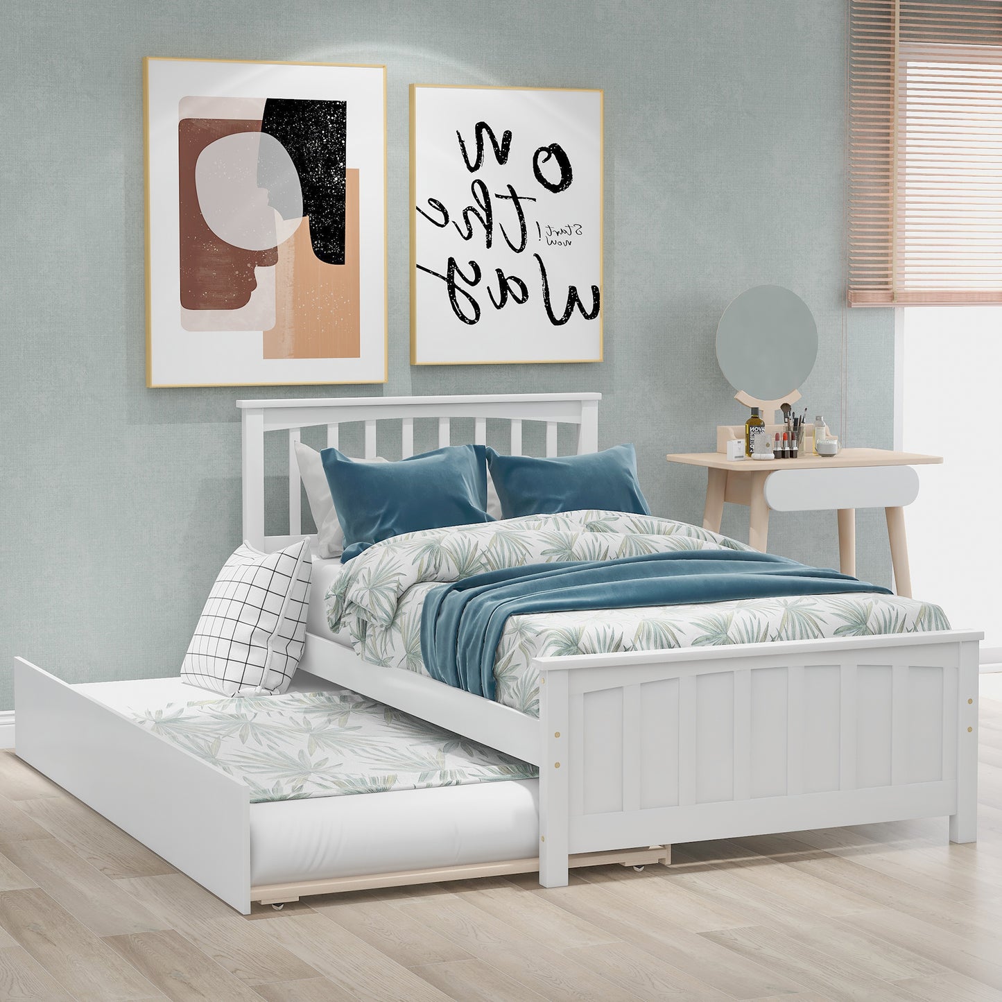 White wooden twin bed with pullout trundle featuring blue and green tropical bedding