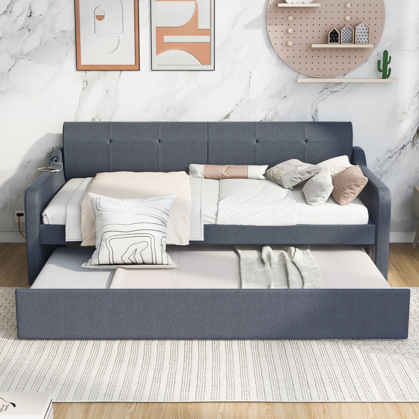 Dark blue upholstered daybed with pullout trundle perfect for small spaces