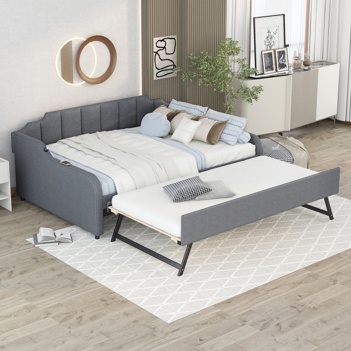 Grey upholstered daybed with trundle pulled out styled with pillows
