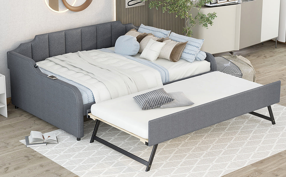Gray upholstered daybed with pullout trundle and integrated USB charging port