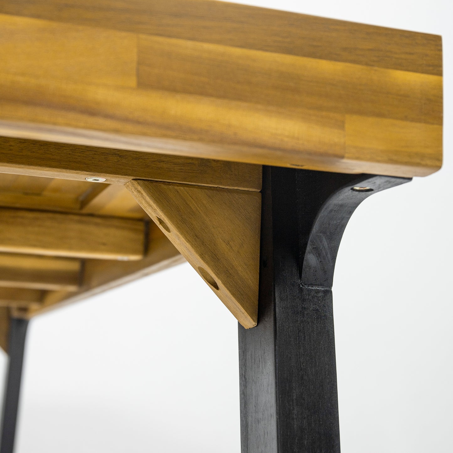 Close up of a rustic wood dining table showing its solid construction and natural grain