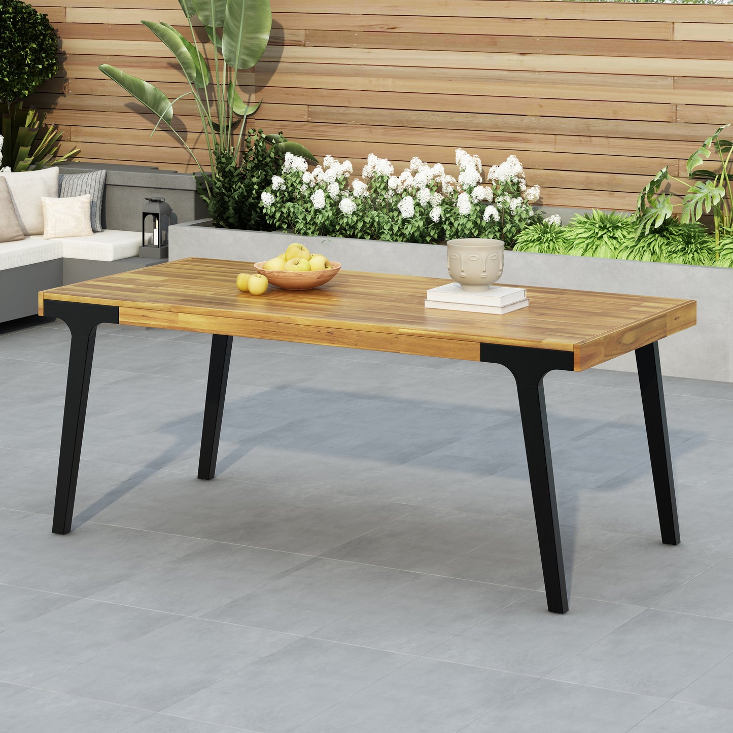 Wooden outdoor dining table with sleek black legs perfect for patio gatherings