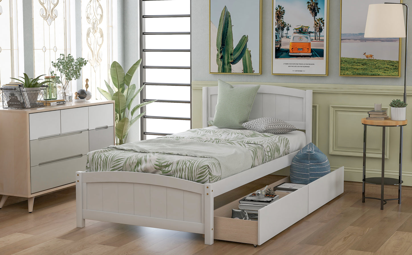 White wooden twin bed with drawers and palm leaf bedding