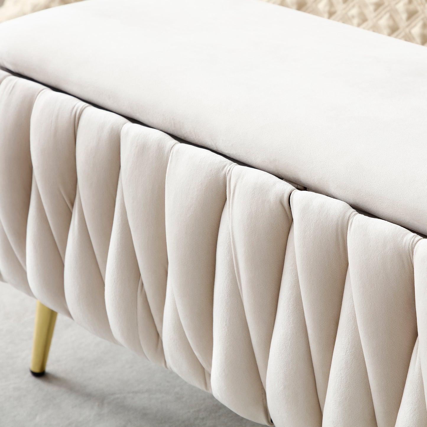 Cream velvet storage ottoman with gold legs and tufted side detail
