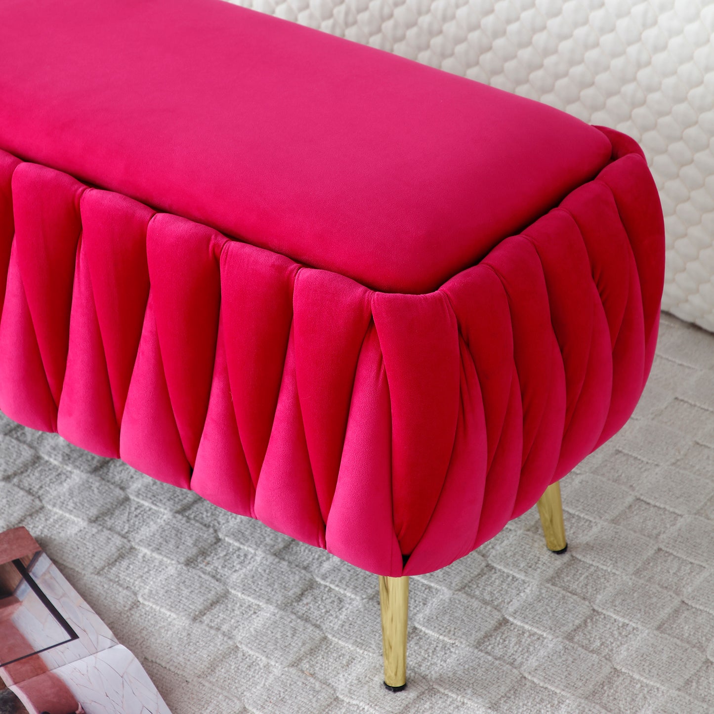 Bright pink velvet bench with pleated sides and gold legs