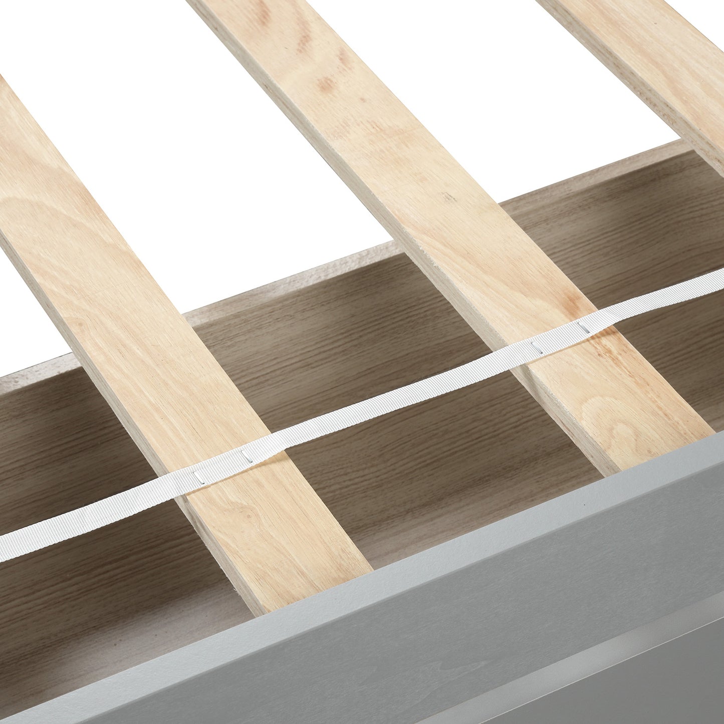 Closeup of light wood slats and white strap on grey wood bed frame