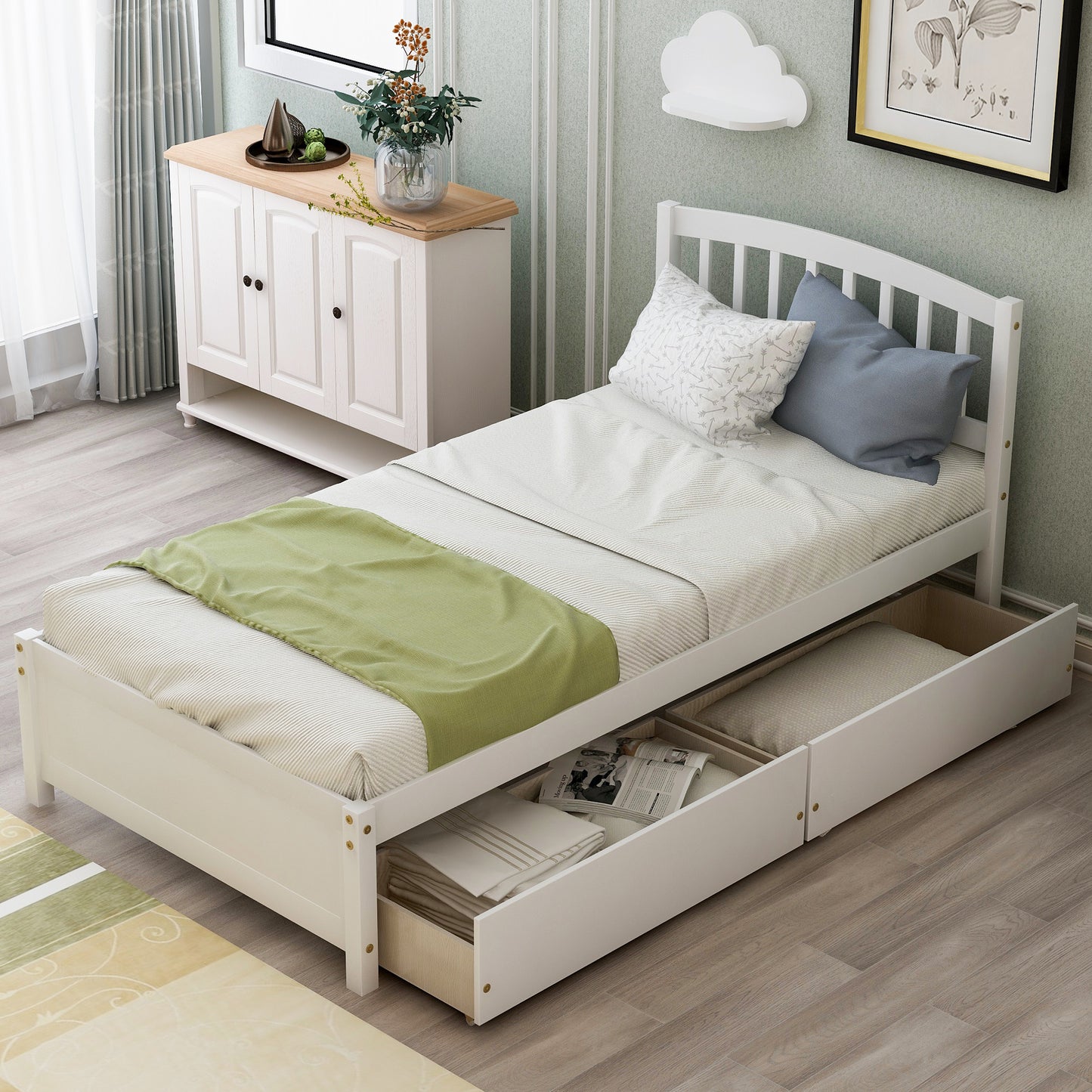 White twin bed with storage drawers and a green throw